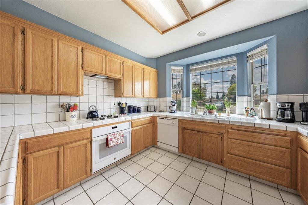3159 Cedar Creek Lane Madera, CA 93637 - Photo 8 of 37 a kitchen with sink cabinets and window