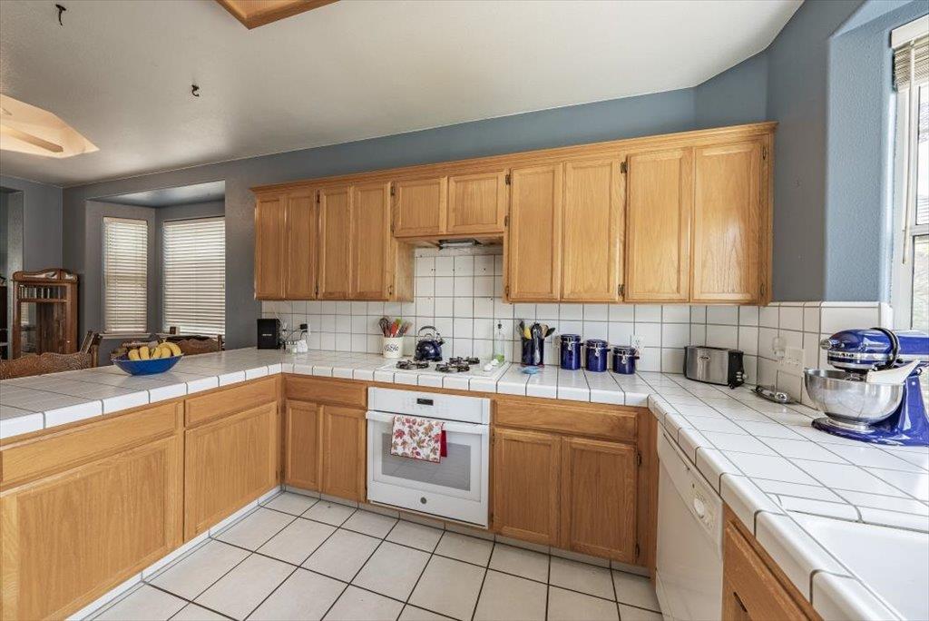 3159 Cedar Creek Lane Madera, CA 93637 - Photo 9 of 37 a kitchen with a sink stove and cabinets