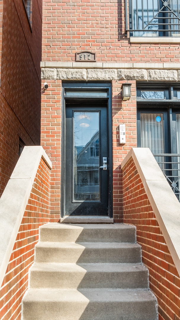 912 West Fletcher Street, Unit 2 Chicago, IL 60657 - Photo 2 of 29 a view of a brick house with large windows