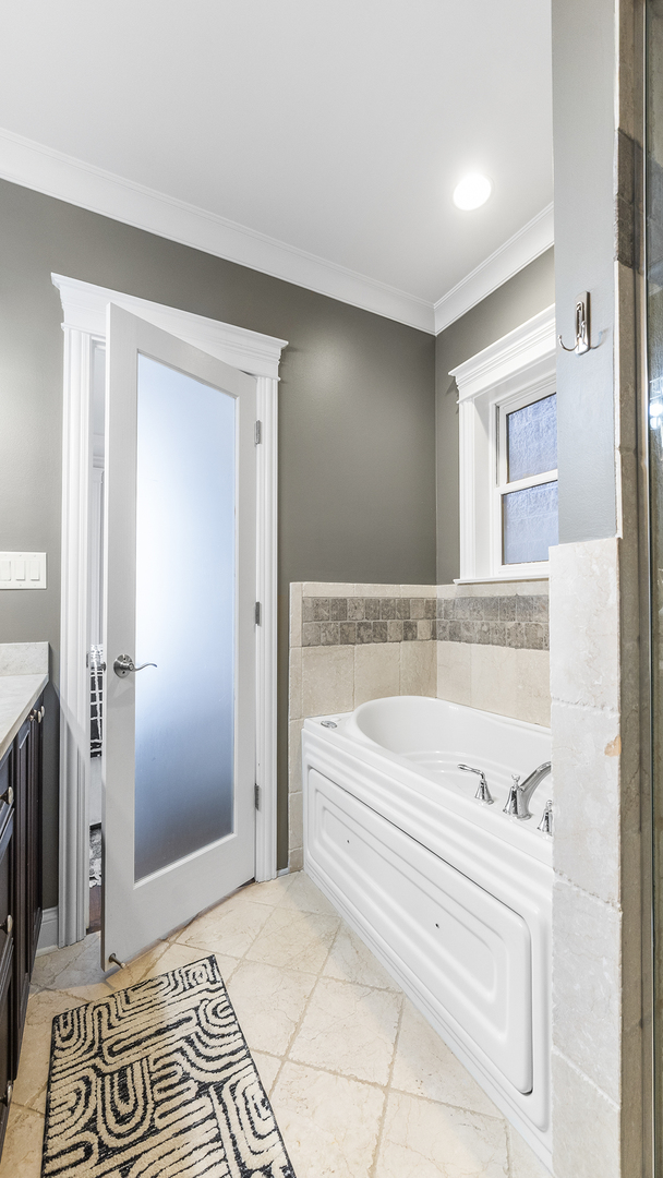 912 West Fletcher Street, Unit 2 Chicago, IL 60657 - Photo 25 of 29 a bathroom with a bathtub and a shower