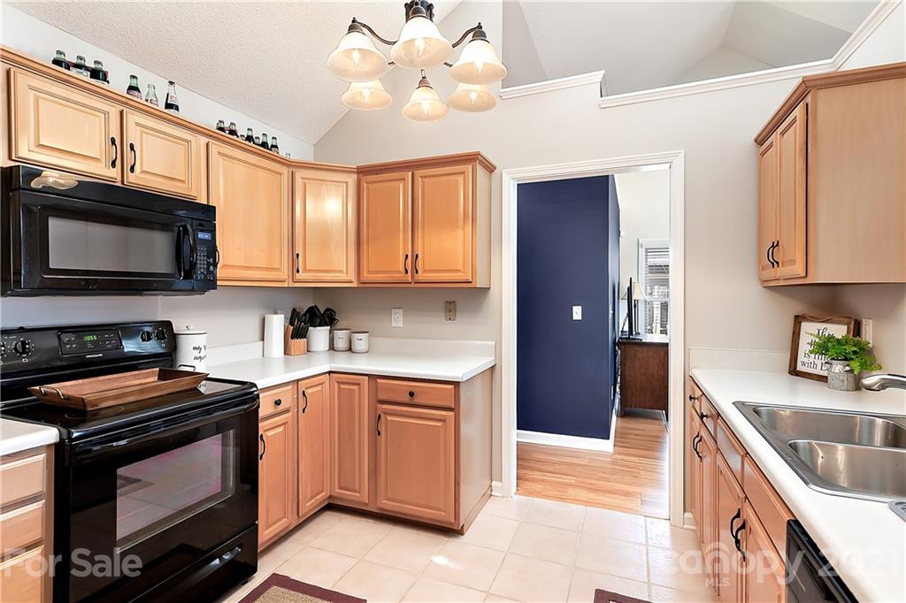 168 Sea Island Boulevard, Unit 26 Fort Mill, SC 29708 - Photo 11 of 17 a kitchen with stainless steel appliances granite countertop a sink stove and microwave