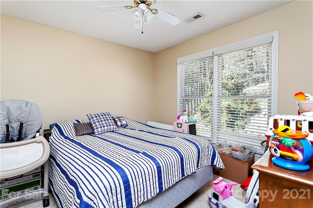 168 Sea Island Boulevard, Unit 26 Fort Mill, SC 29708 - Photo 15 of 17 a bedroom with bed and a window