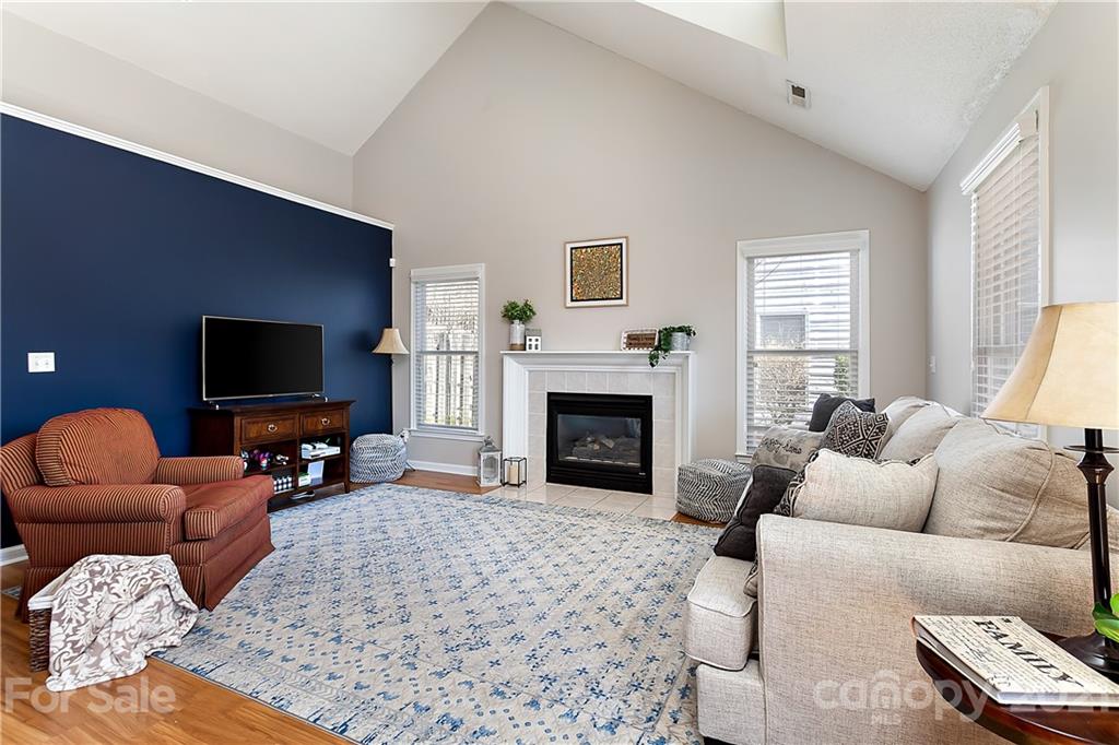 168 Sea Island Boulevard, Unit 26 Fort Mill, SC 29708 - Photo 4 of 17 a living room with furniture a flat screen tv and a fireplace