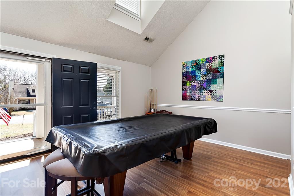 168 Sea Island Boulevard, Unit 26 Fort Mill, SC 29708 - Photo 7 of 17 a living room with a table chairs and a refrigerator