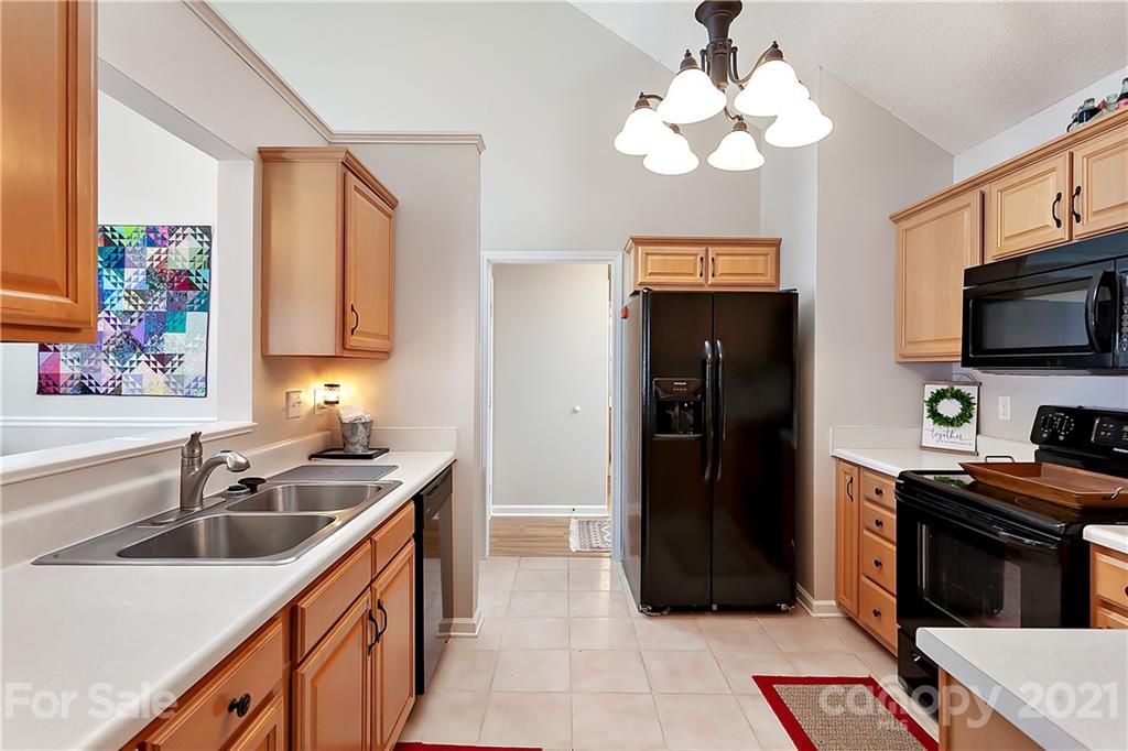 168 Sea Island Boulevard, Unit 26 Fort Mill, SC 29708 - Photo 10 of 17 a kitchen with stainless steel appliances a sink stove and refrigerator