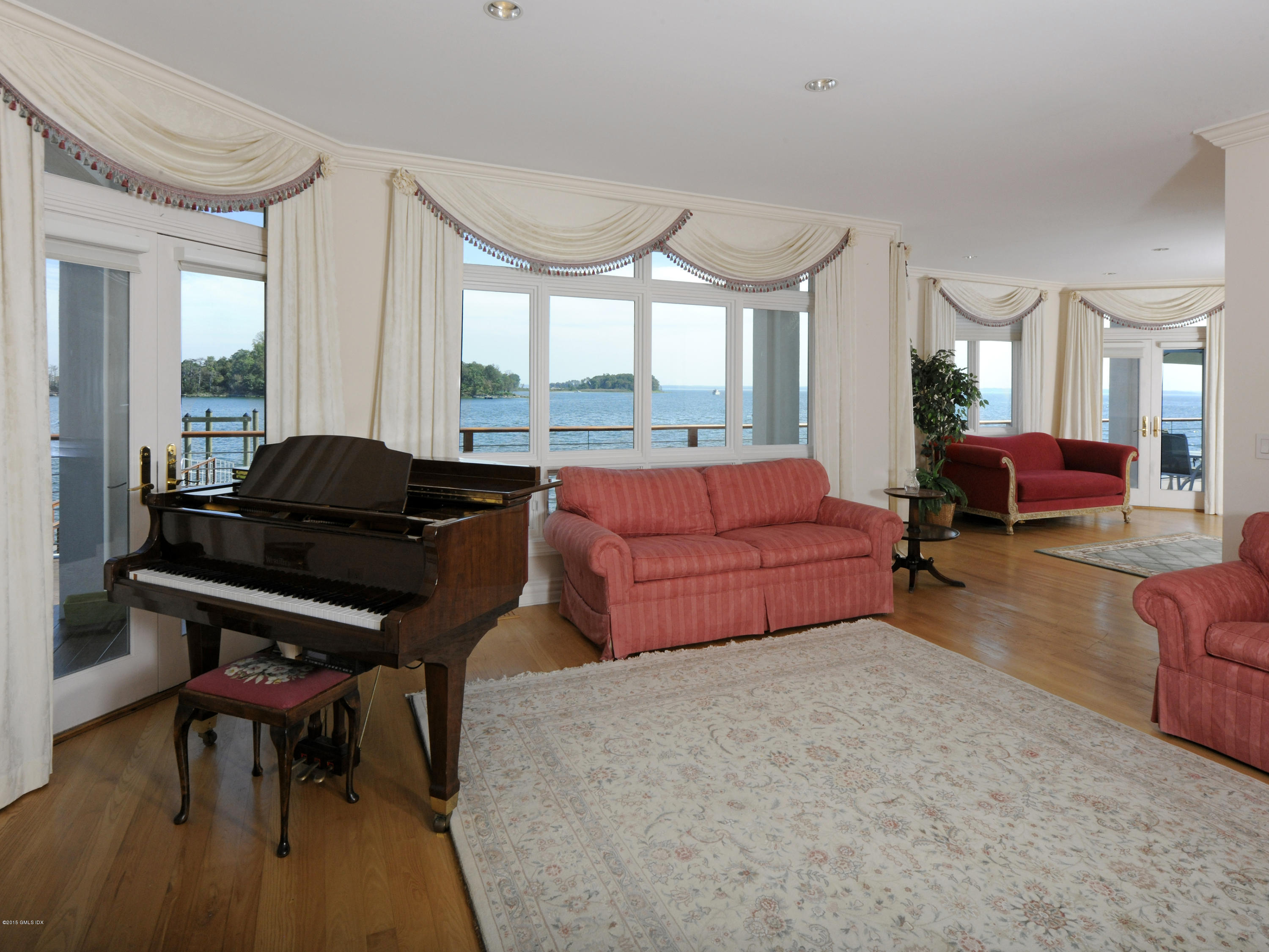71 Byram Shore Road Greenwich, CT 06830 - Photo 11 of 32 a living room with furniture a rug and a large window