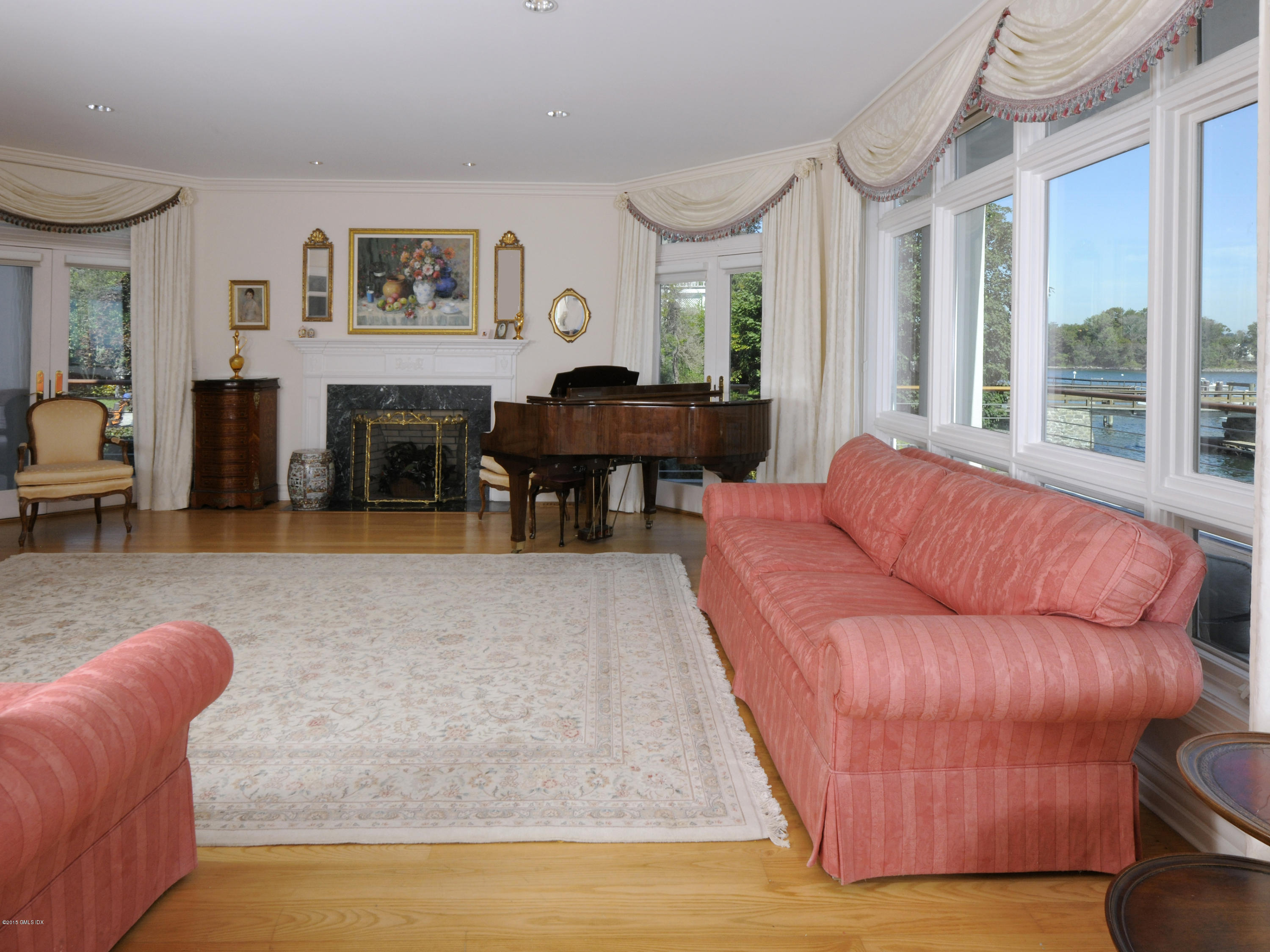 71 Byram Shore Road Greenwich, CT 06830 - Photo 12 of 32 a living room with furniture and a fireplace