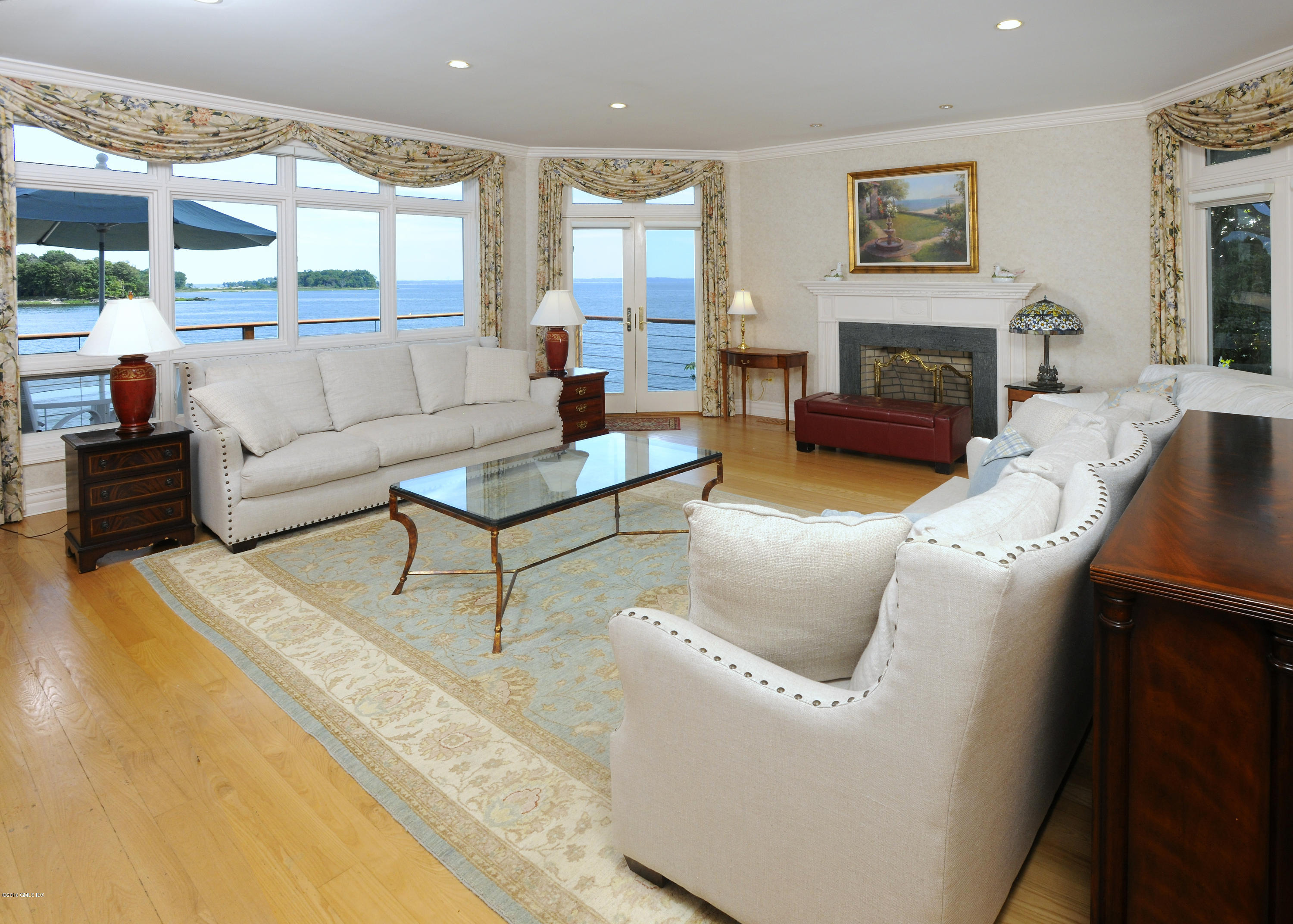 71 Byram Shore Road Greenwich, CT 06830 - Photo 14 of 32 a living room with furniture fireplace and a large window