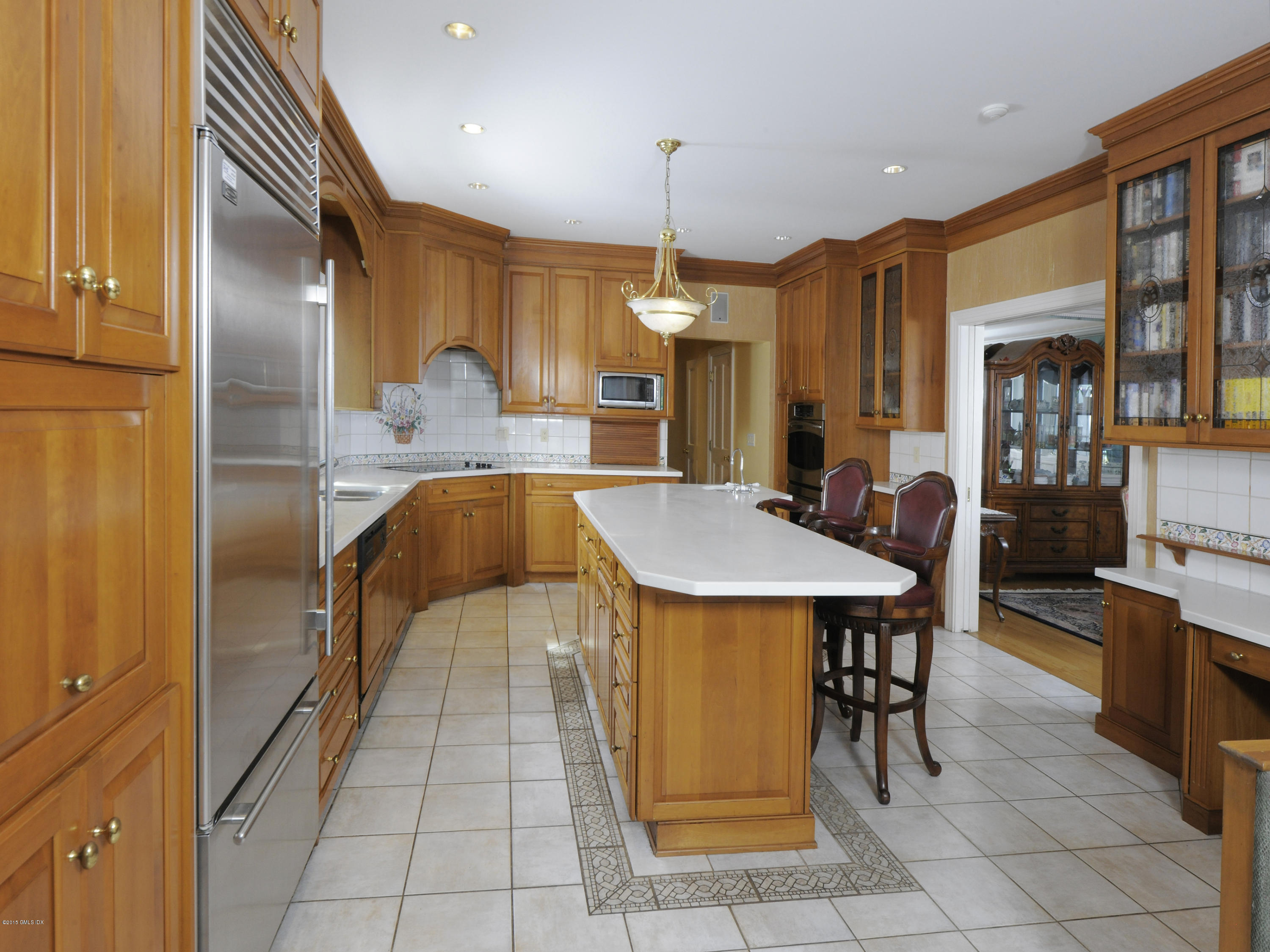 71 Byram Shore Road Greenwich, CT 06830 - Photo 17 of 32 a dining hall with stainless steel appliances kitchen island granite countertop a table chairs and a refrigerator