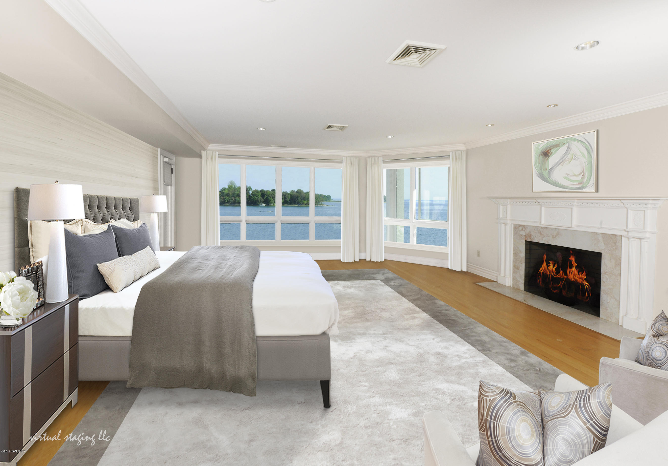 71 Byram Shore Road Greenwich, CT 06830 - Photo 20 of 32 a spacious bedroom with a large bed and a fireplace