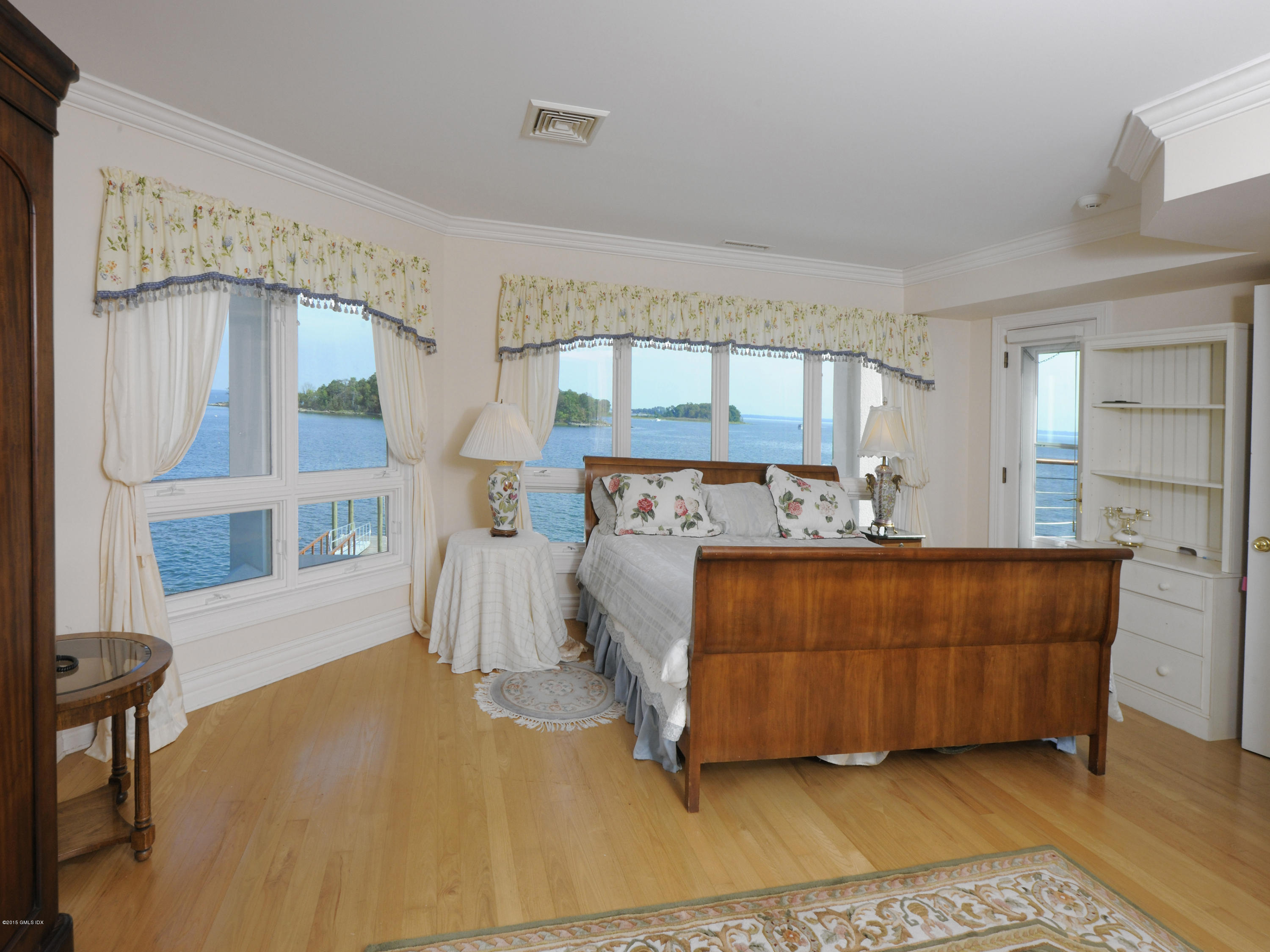 71 Byram Shore Road Greenwich, CT 06830 - Photo 24 of 32 a bed room with a bed and a chair