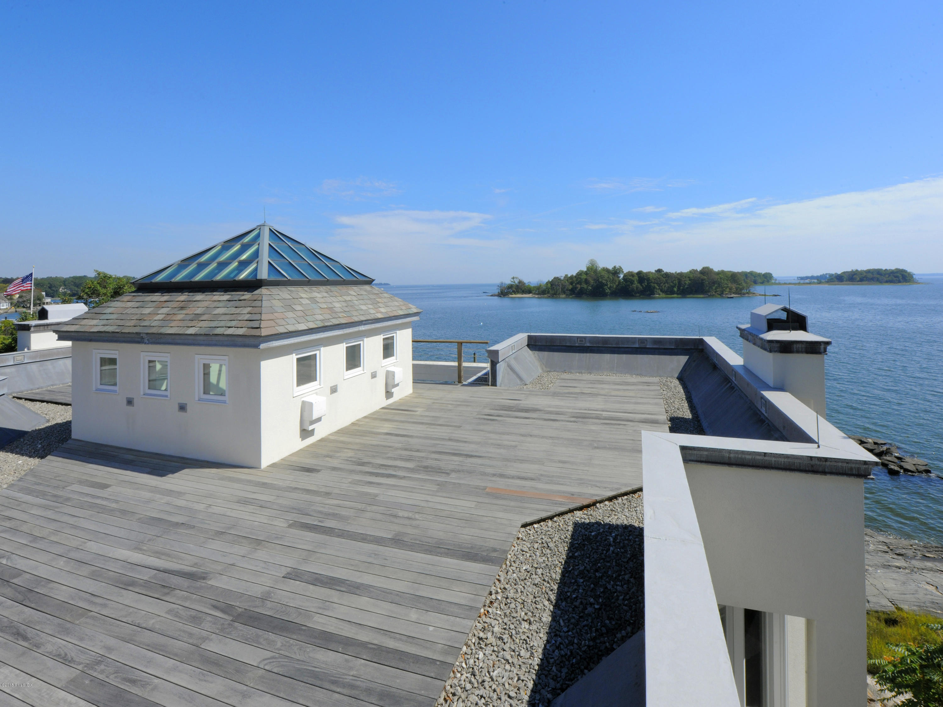 71 Byram Shore Road Greenwich, CT 06830 - Photo 27 of 32 a roof deck with table and chairs