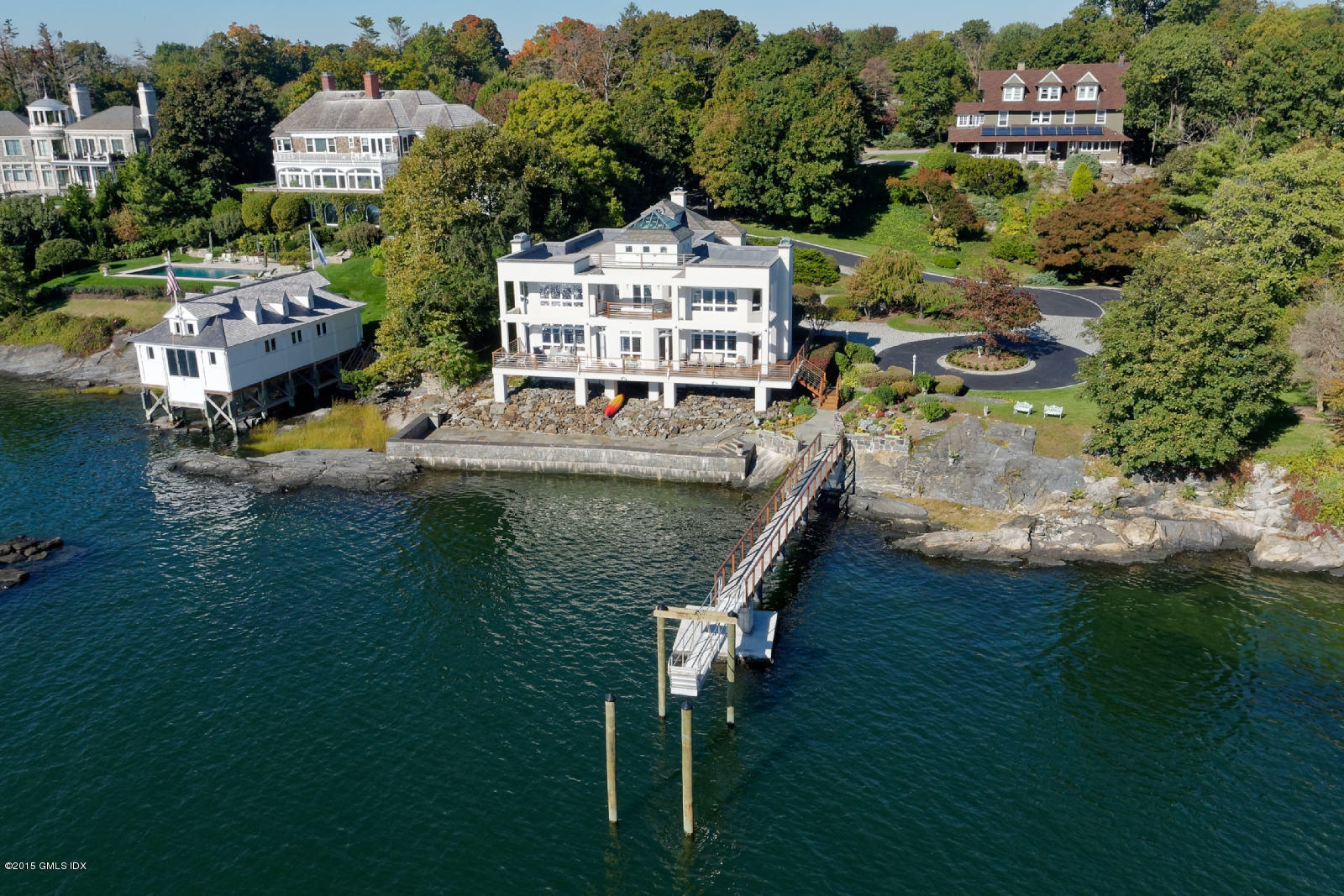 71 Byram Shore Road Greenwich, CT 06830 - Photo 3 of 32 an aerial view of a house with swimming pool patio swimming pool and outdoor seating