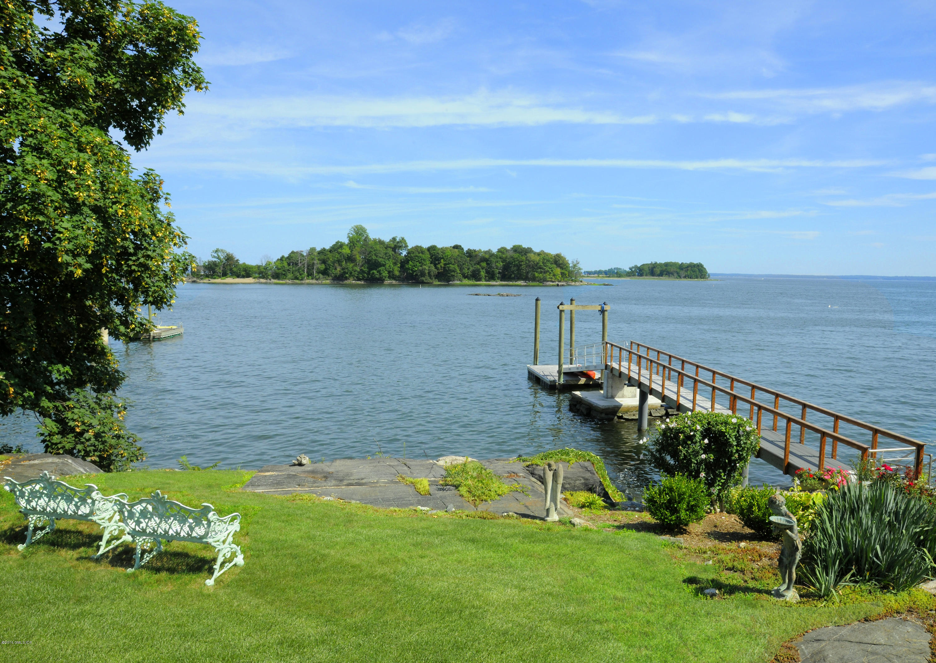 71 Byram Shore Road Greenwich, CT 06830 - Photo 6 of 32 a view of a lake with a yard