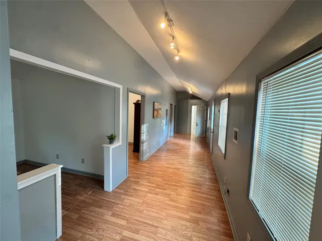 a view of a hallway with wooden floor