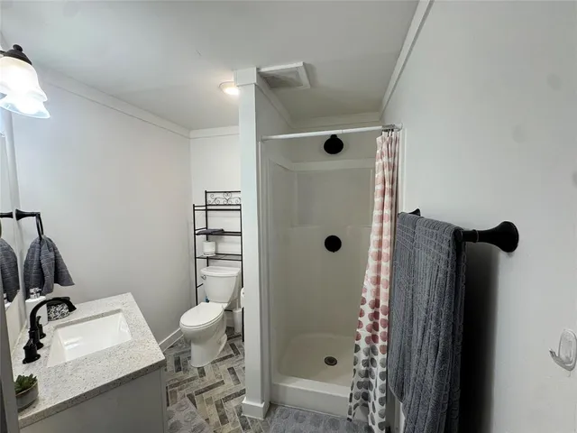 a bathroom with a sink toilet and shower