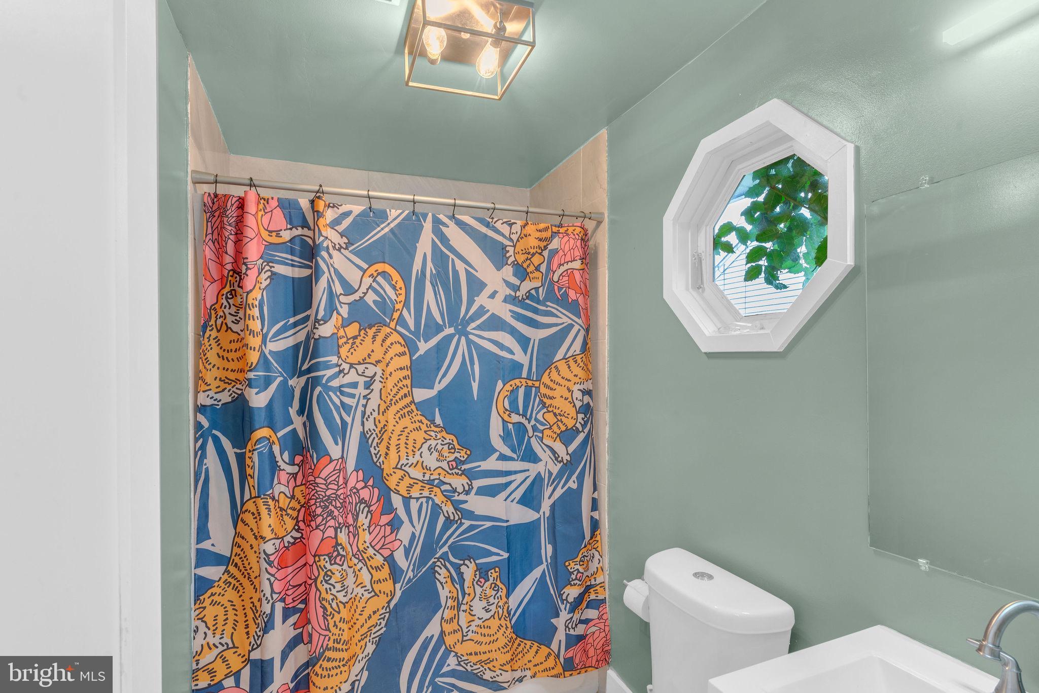 629 Polk Street Riverside, NJ 08075 - Photo 11 of 42 a bathroom with a toilet and a shower curtain