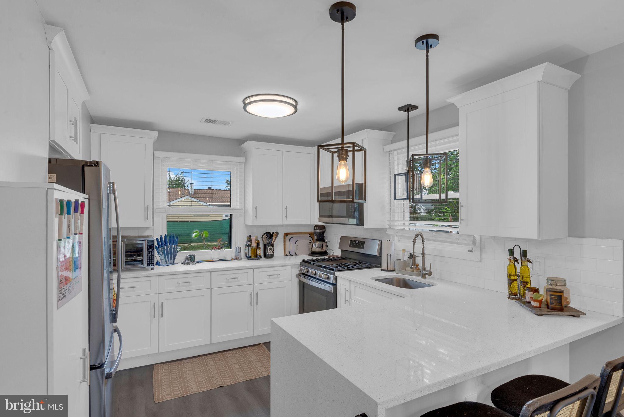 629 Polk Street Riverside, NJ 08075 - Photo 15 of 42 a kitchen with a sink a stove a refrigerator and cabinets