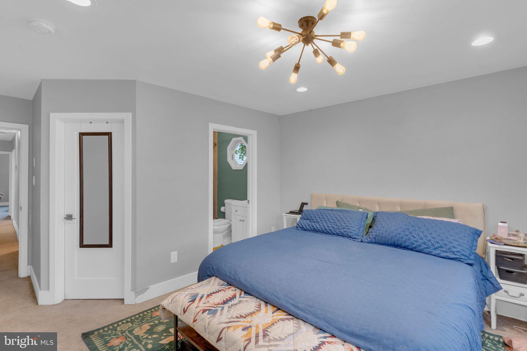 629 Polk Street Riverside, NJ 08075 - Photo 22 of 42 a bedroom with a bed and a chandelier