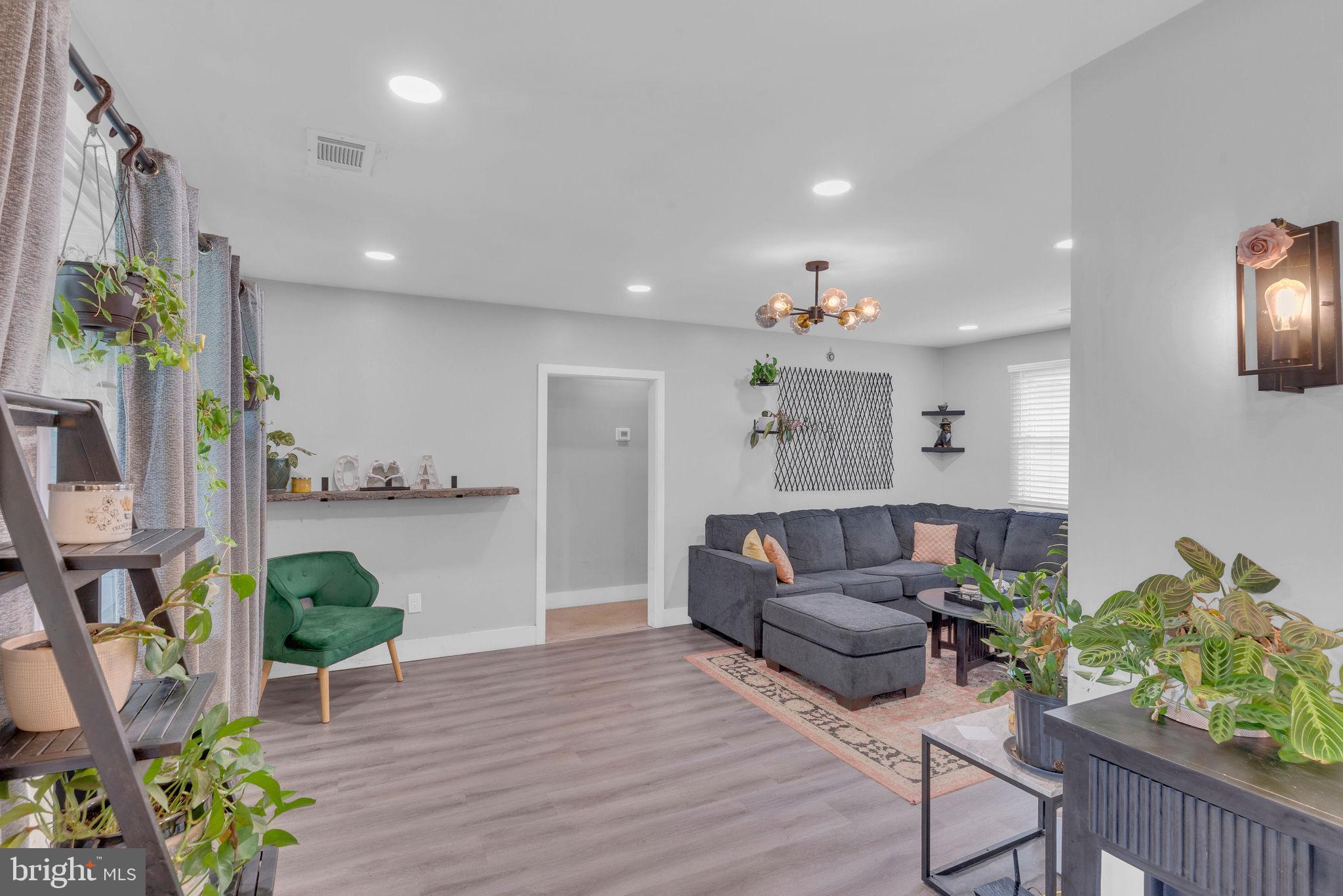 629 Polk Street Riverside, NJ 08075 - Photo 6 of 42 a living room with furniture and a chandelier