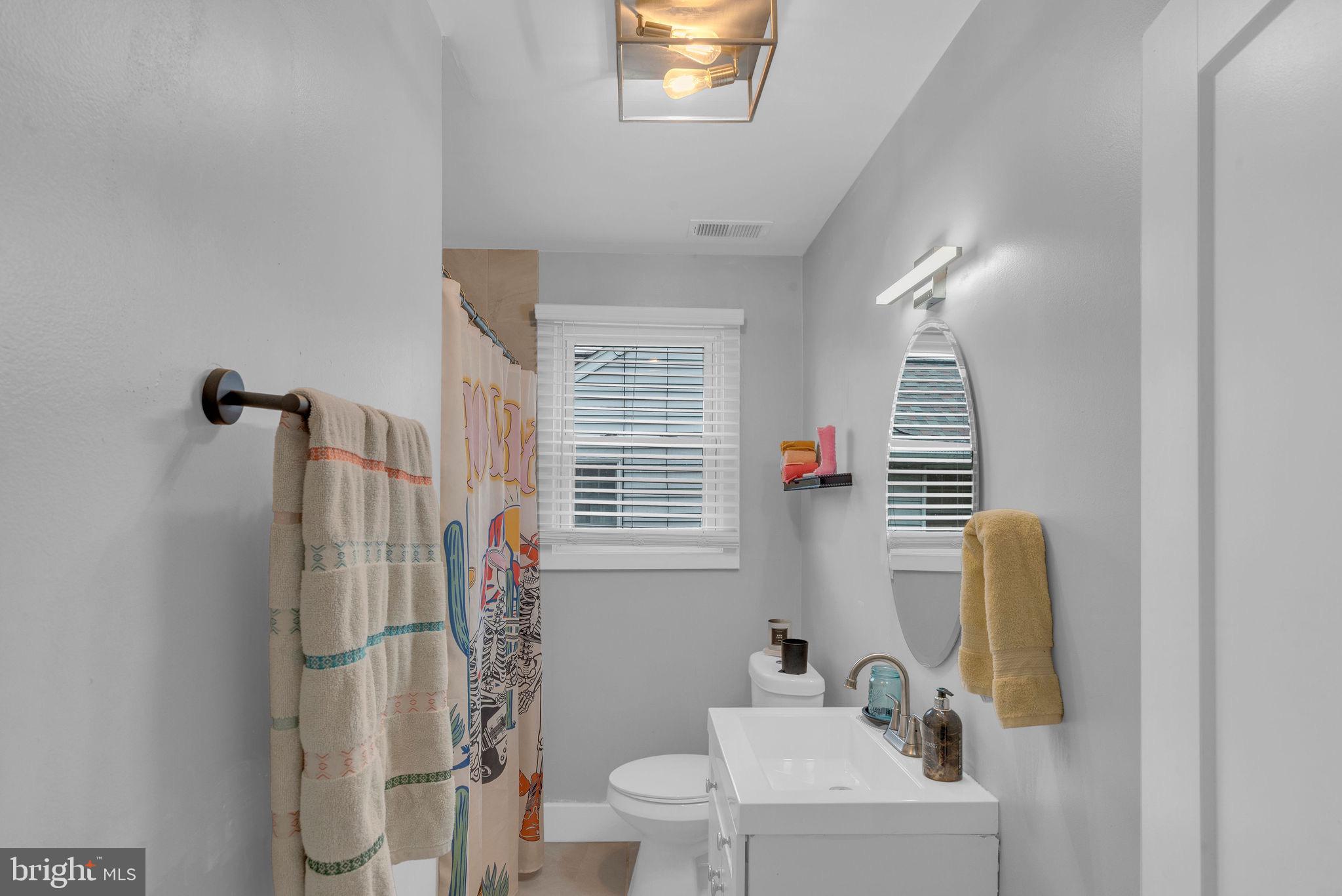 629 Polk Street Riverside, NJ 08075 - Photo 10 of 42 a bathroom with a sink toilet and shower