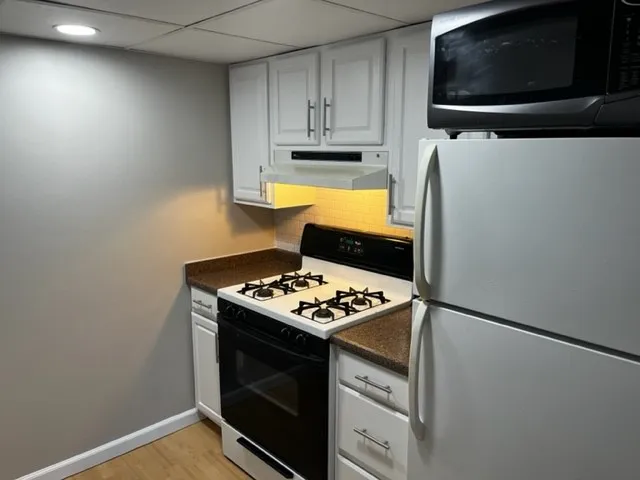 a kitchen with stainless steel appliances a stove a microwave and cabinets