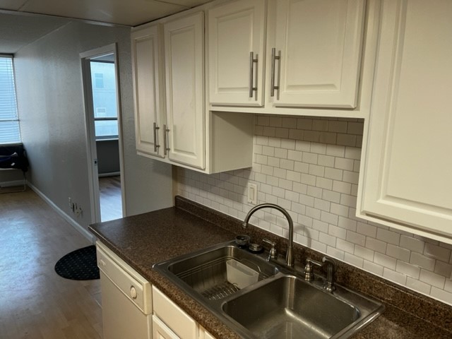 1800 Lavaca Street, Unit 607 Austin, TX 78701 - Photo 15 of 22 a kitchen with granite countertop a sink stainless steel appliances and cabinets