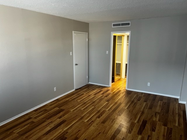 1800 Lavaca Street, Unit 607 Austin, TX 78701 - Photo 20 of 22 a view of an empty room with wooden floor and a window