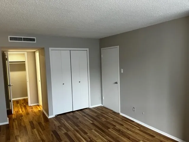 a view of room with window and wooden floor