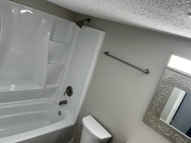 a bathroom with a bathtub and toilet