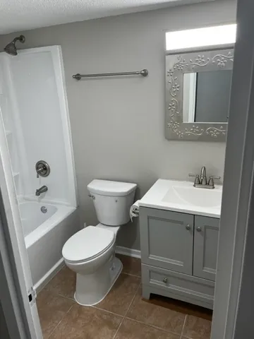 a white toilet sitting next to a bathroom sink