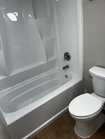 a bathroom with a toilet and a bathtub