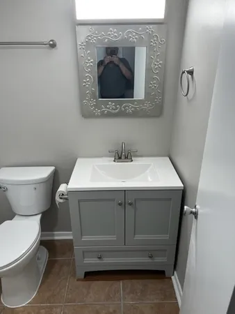 a bathroom with a sink toilet and mirror