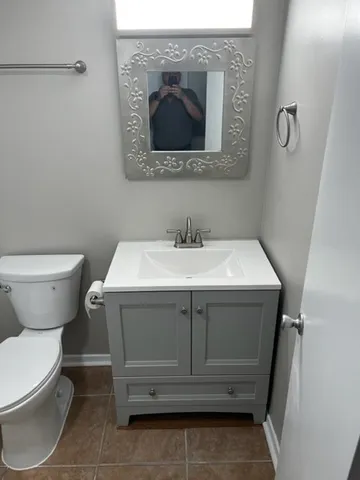 a bathroom with a sink toilet and mirror