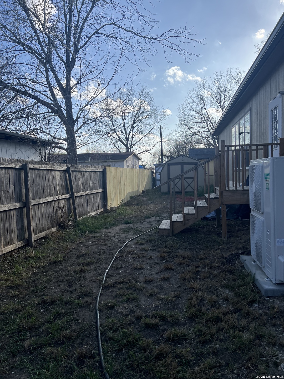 218 West 2nd Street Elmendorf, TX 78112 - Photo 12 of 13 a backyard of a house with lots of green space