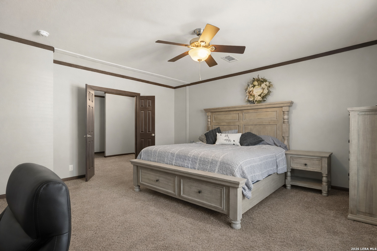 218 West 2nd Street Elmendorf, TX 78112 - Photo 4 of 13 a bedroom with a bed and a chandelier