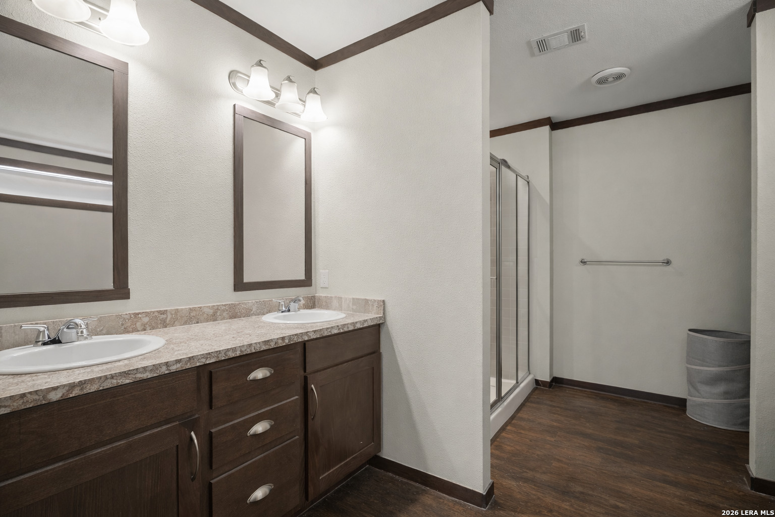 218 West 2nd Street Elmendorf, TX 78112 - Photo 8 of 13 a bathroom with a double vanity sink and mirror