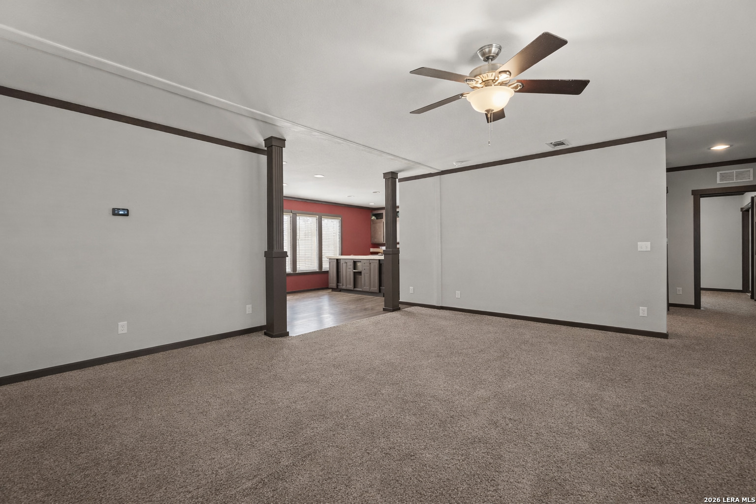 218 West 2nd Street Elmendorf, TX 78112 - Photo 10 of 13 a view of a livingroom with a ceiling fan and refrigerator