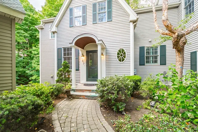 a view of a house with potted plants