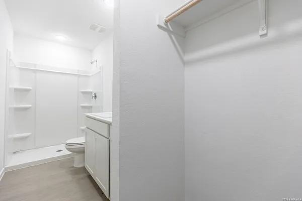 a bathroom with a toilet and a shower