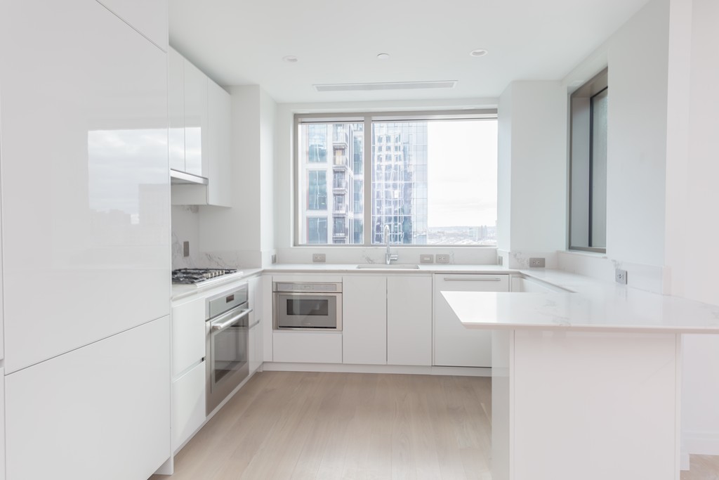 a kitchen with granite countertop white cabinets and white appliances