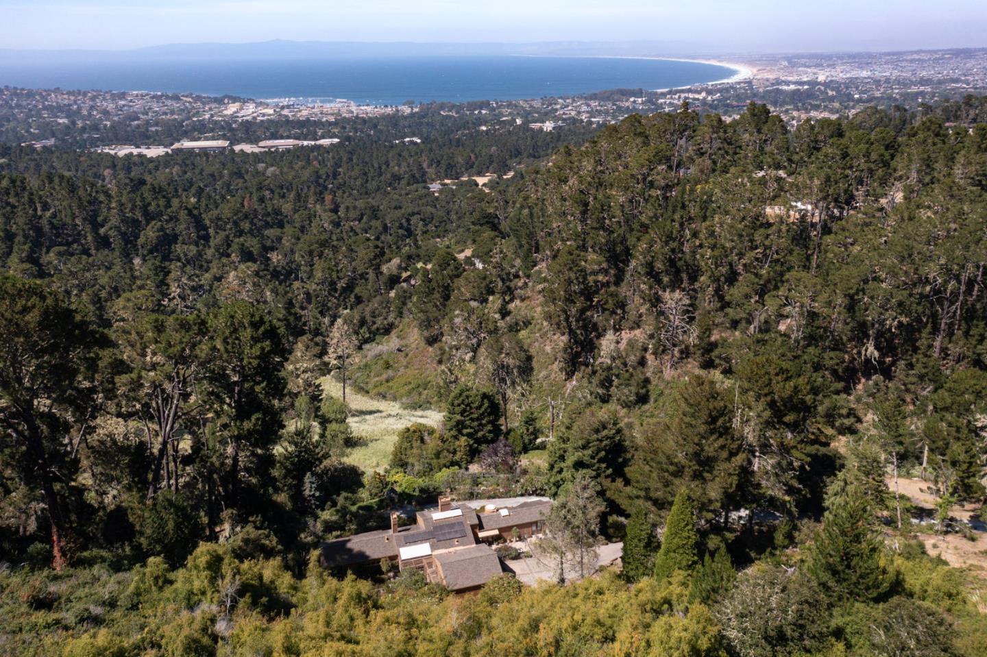540 Aguajito Road Carmel, CA 93923 - Photo 1 of 35 an aerial view of a city and mountain view in back