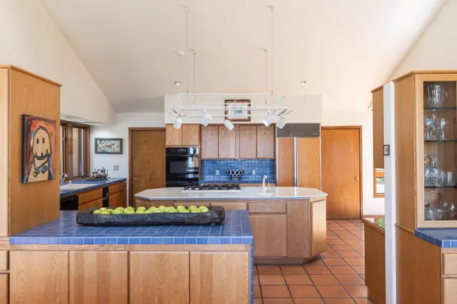 a kitchen with stainless steel appliances a sink stove and cabinets