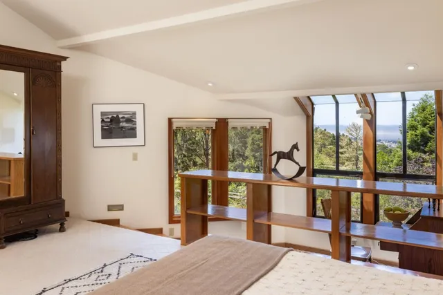 a bedroom with furniture and large window