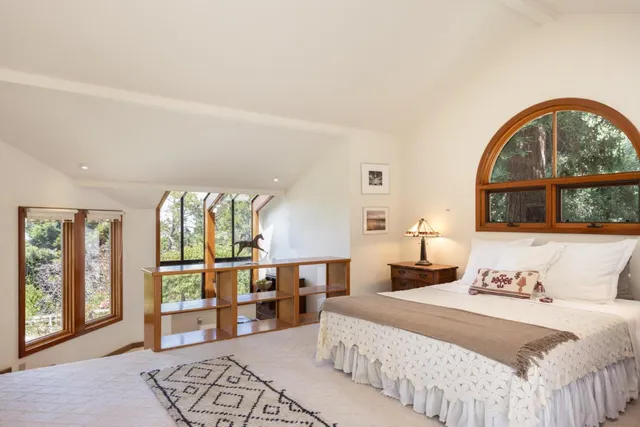 a bedroom with a large bed and a window