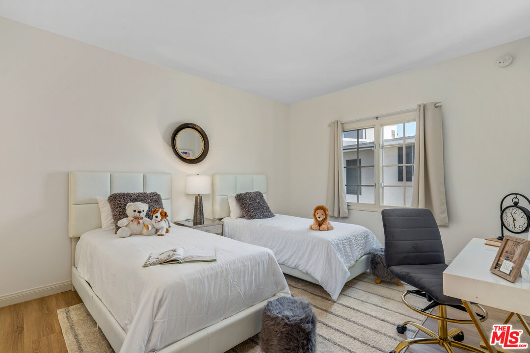 1663 Malcolm Avenue, Unit 103 Los Angeles, CA 90024 - Photo 27 of 45 a bedroom with two beds and painting on the wall