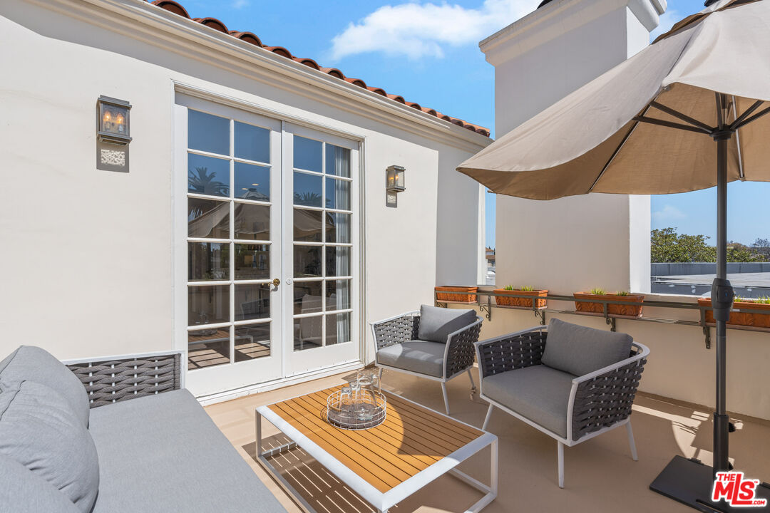 1663 Malcolm Avenue, Unit 103 Los Angeles, CA 90024 - Photo 40 of 45 a balcony with furniture and a potted plant
