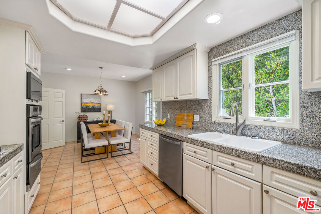 1663 Malcolm Avenue, Unit 103 Los Angeles, CA 90024 - Photo 10 of 45 a kitchen with stainless steel appliances granite countertop a stove a sink and a microwave