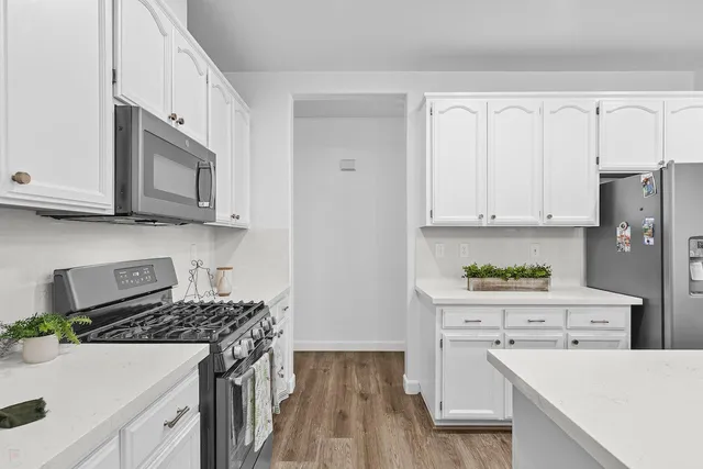 a spacious bathroom with a granite countertop sink a large mirror and a bathtub