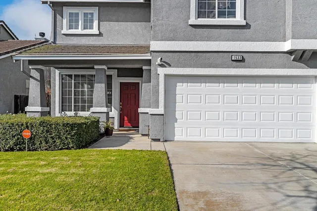 a living room with furniture a clock and a window
